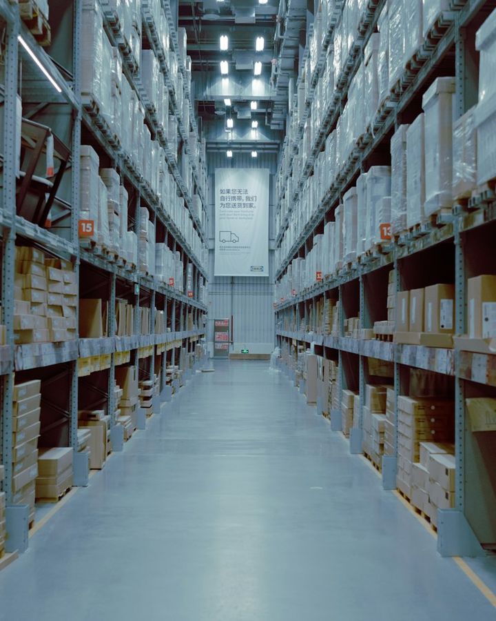 Tall shelving racks stacked with boxes in a warehouse aisle
